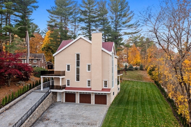 view of side of home with a garage and a lawn