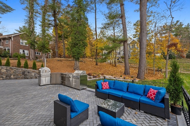 view of patio / terrace with an outdoor living space, area for grilling, and an outdoor kitchen