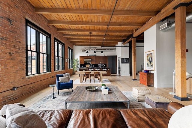 living room with brick wall, light hardwood / wood-style floors, wood ceiling, and beam ceiling