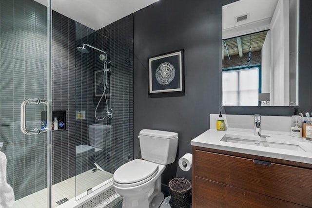 bathroom with toilet, a shower with shower door, and vanity