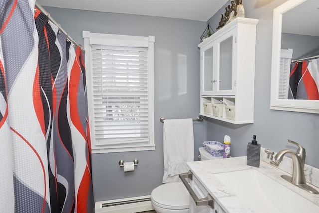 bathroom featuring baseboard heating, vanity, and toilet