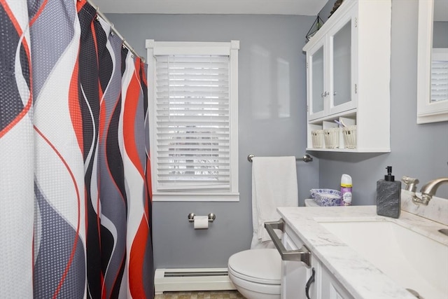 bathroom featuring vanity, baseboard heating, and toilet