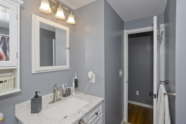 bathroom with hardwood / wood-style flooring and vanity