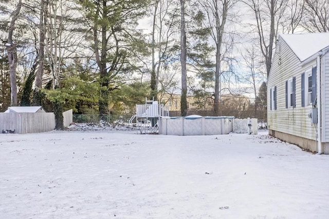 yard layered in snow featuring a covered pool