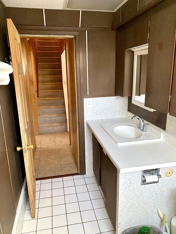 bathroom with tile patterned flooring and vanity