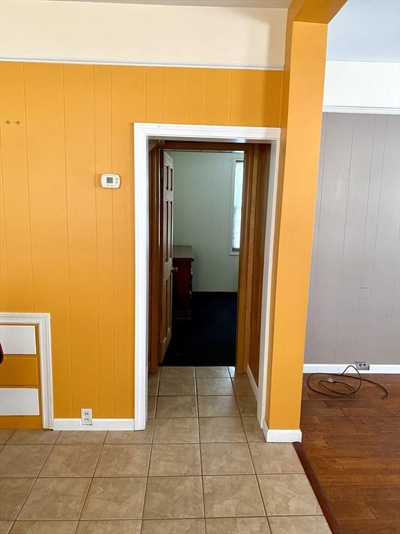 hallway with tile patterned floors