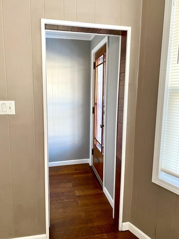 hallway with dark hardwood / wood-style flooring