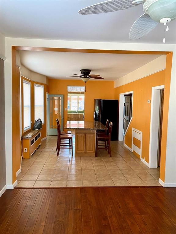 dining space featuring ceiling fan, sink, and light hardwood / wood-style floors