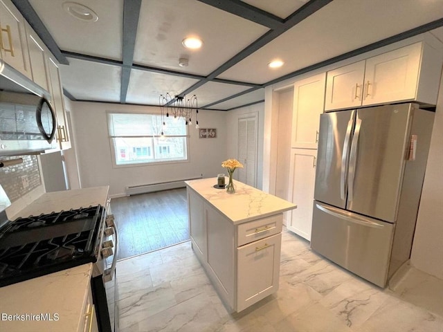 kitchen featuring marble finish floor, stainless steel appliances, baseboard heating, and light stone counters