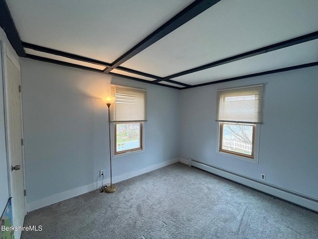 spare room with baseboards, carpet floors, and a baseboard radiator