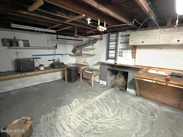 unfinished below grade area featuring a workshop area