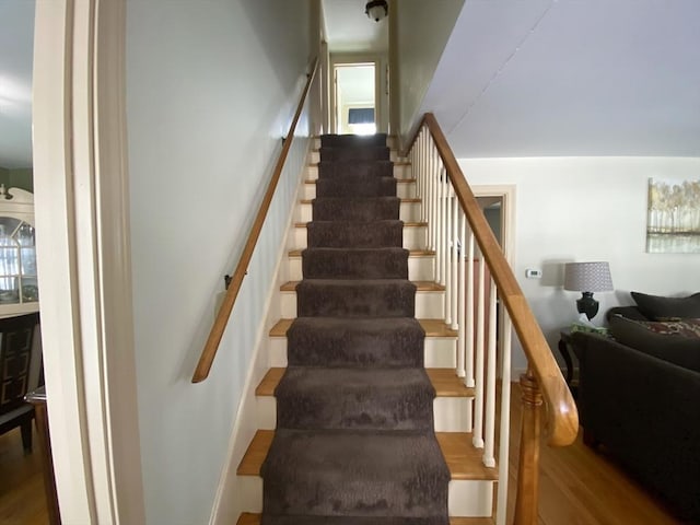 staircase with hardwood / wood-style flooring