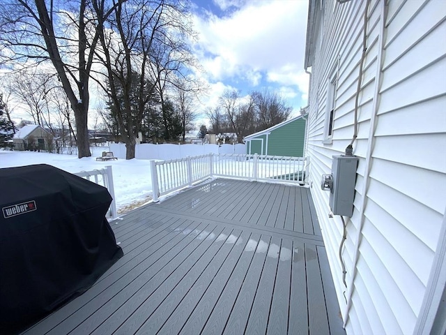 snow covered deck featuring a grill