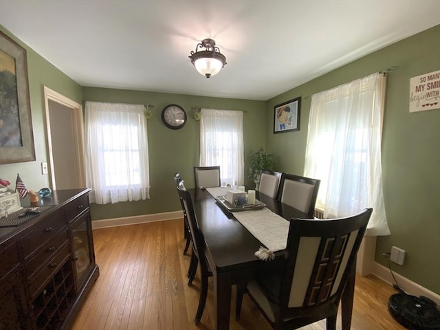 dining area with a wealth of natural light and light hardwood / wood-style floors