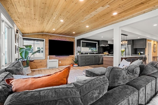 living room with wooden walls, light wood-style flooring, recessed lighting, vaulted ceiling, and wood ceiling