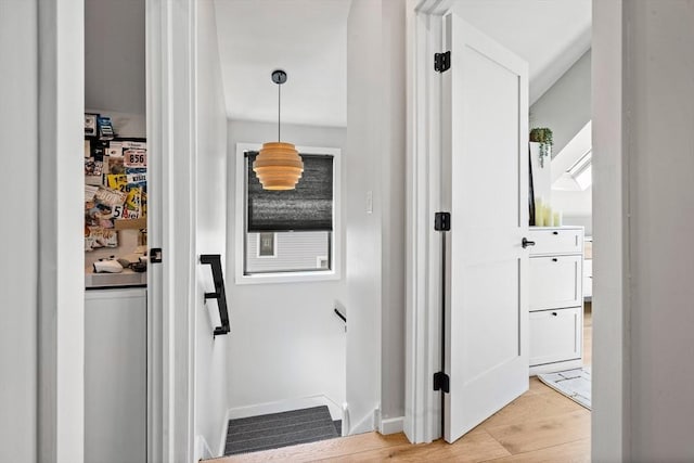 hallway featuring baseboards and light wood-style floors