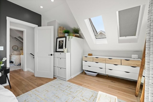 bedroom featuring recessed lighting, baseboards, lofted ceiling with skylight, and light wood-style floors