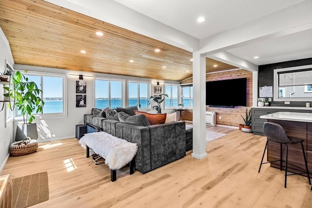 living room featuring recessed lighting, baseboards, and light wood-style flooring