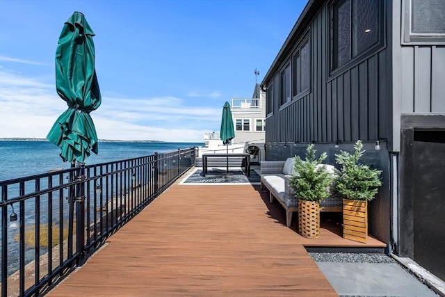 view of property's community featuring a water view and an outdoor living space