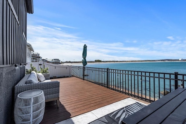 wooden terrace featuring a water view