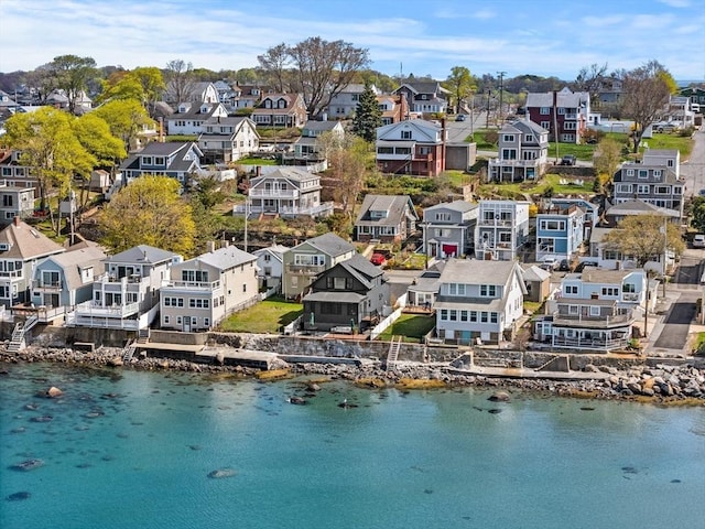drone / aerial view with a water view and a residential view