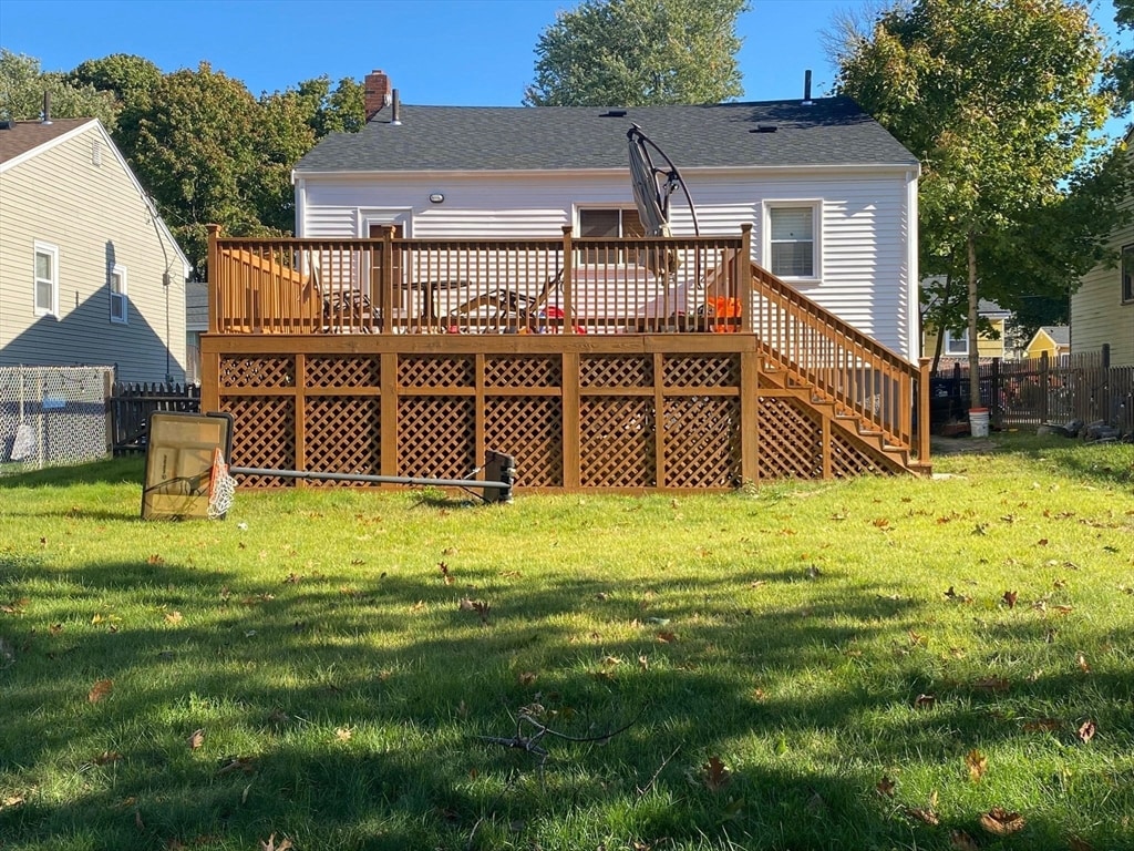 back of house with a yard and a wooden deck