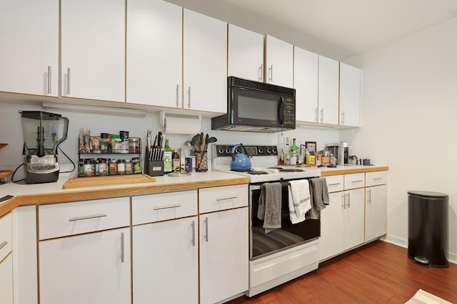 kitchen featuring dark wood-type flooring, white cabinets, and white range with electric stovetop