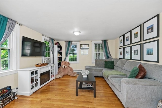 251 Main St, Ashland, MA 01721 - living area featuring light wood finished floors and a baseboard heating unit
