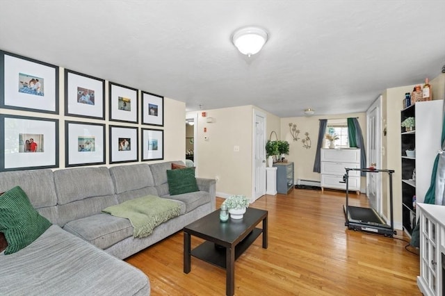 251 Main St, Ashland, MA 01721 - living room featuring a baseboard heating unit and light wood-style floors