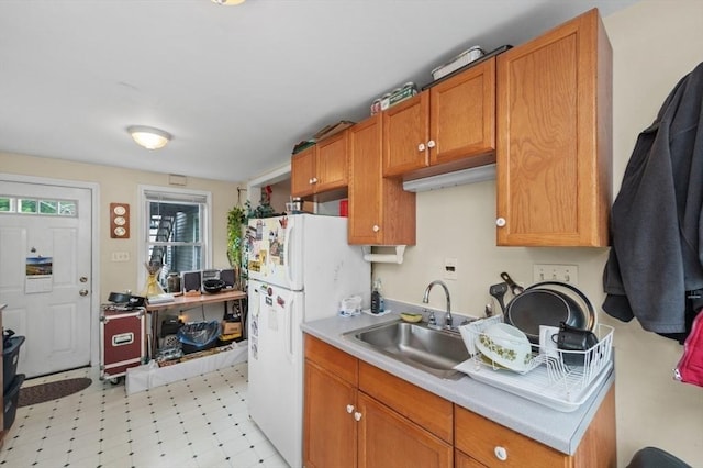 251 Main St, Ashland, MA 01721 - kitchen featuring freestanding refrigerator, light countertops, brown cabinets, and light flooring