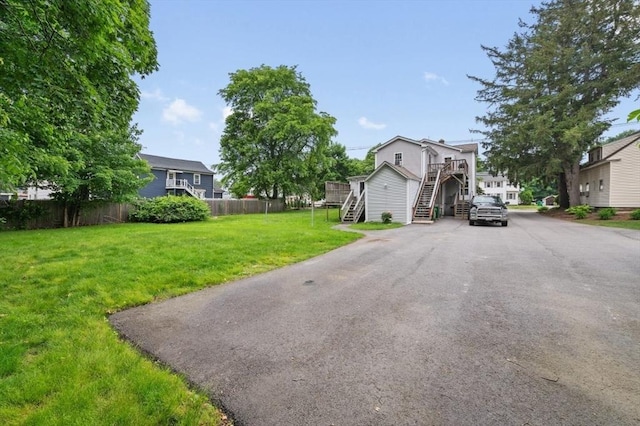 251 Main St, Ashland, MA 01721 - view of front facade with stairway, asphalt driveway, and a deck