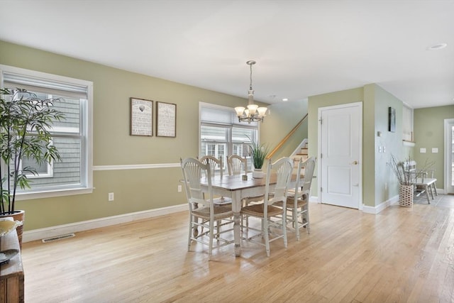 13 11th St W, Salisbury, MA 01952 - dining space featuring healthy amount of natural light, light wood-style flooring, a chandelier, and baseboards
