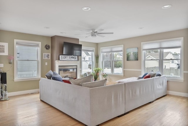 13 11th St W, Salisbury, MA 01952 - living area with baseboards, a ceiling fan, light wood-style flooring, a glass covered fireplace, and recessed lighting