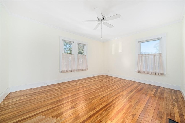 spare room with ceiling fan, crown molding, and wood-type flooring