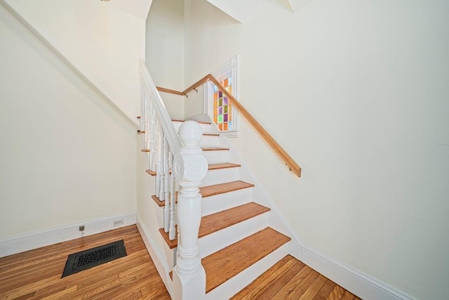 staircase featuring hardwood / wood-style flooring