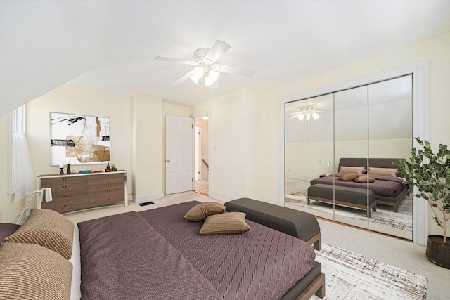 carpeted bedroom featuring a closet and ceiling fan