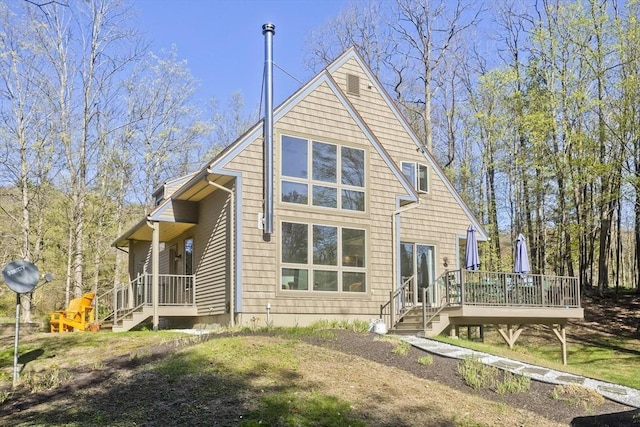 rear view of house featuring a deck