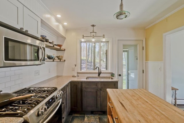 kitchen with a baseboard heating unit, a sink, wood counters, open shelves, and appliances with stainless steel finishes