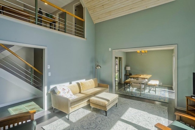 living area featuring wood ceiling, a chandelier, high vaulted ceiling, wood finished floors, and stairway