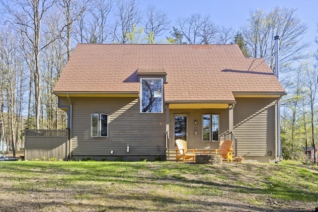 rear view of property with a lawn