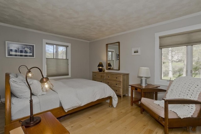 bedroom featuring crown molding and light wood-style flooring
