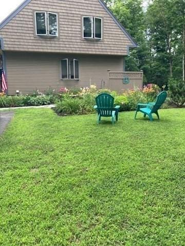 rear view of property with a yard