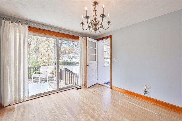 interior space featuring a notable chandelier and light wood-type flooring