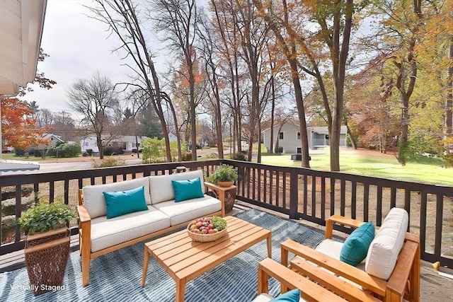 wooden terrace with an outdoor living space