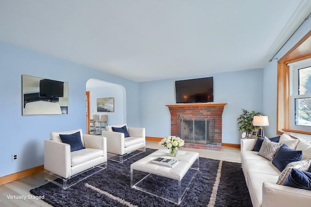 living room featuring hardwood / wood-style flooring and a fireplace