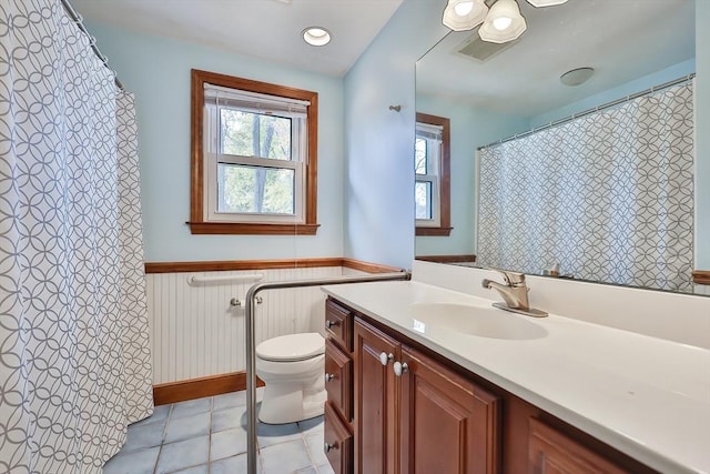 bathroom with vanity, tile patterned flooring, and toilet