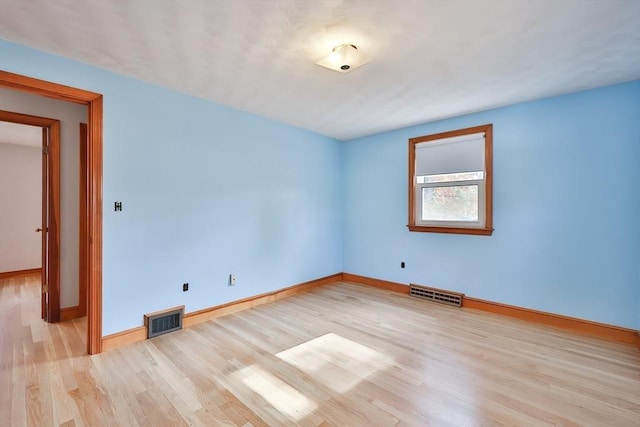 unfurnished room with light hardwood / wood-style floors