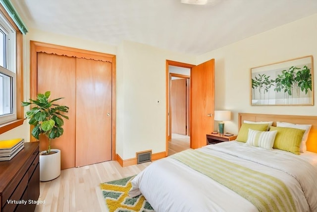 bedroom featuring light hardwood / wood-style floors and a closet