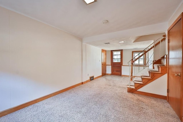 basement featuring light colored carpet