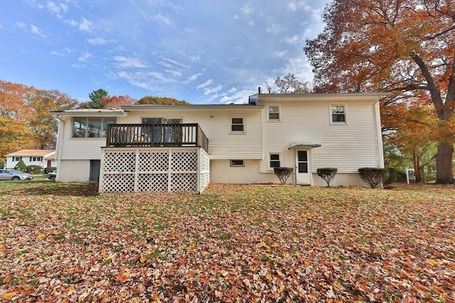 back of property featuring a sunroom and a deck